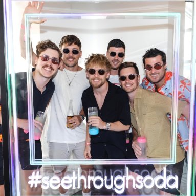 White selfie frame with a branded hashtag made by Custom Neon® for the brand launch event @sodashades