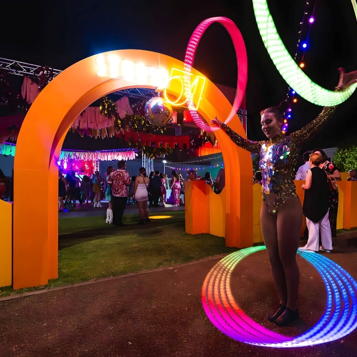 Weatherproof Custom Neon® Studio 54 sign on an arch at the entrance to an open-air corporate event organised by @ultimo_catering
