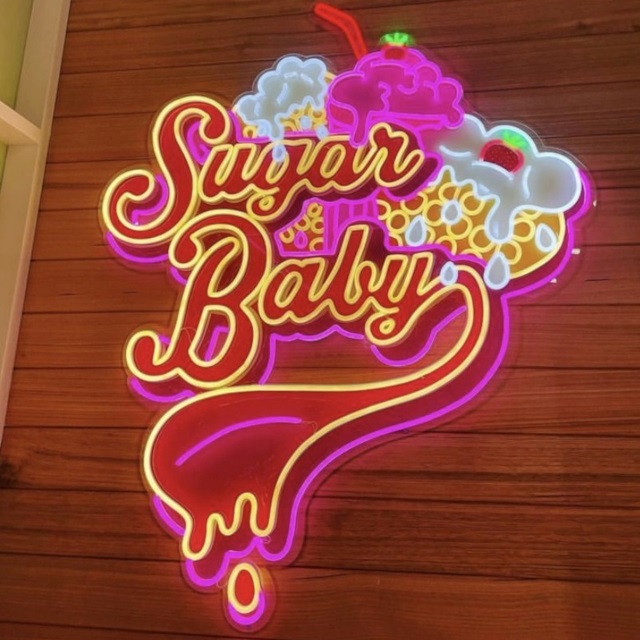 Custom Neon® multi-coloured logo sign on wooden wall @sugarbabyhyperdome