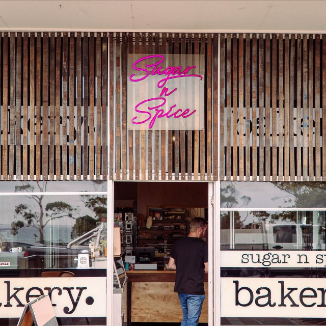 Pink Custom Neon® outdoor bakery name sign @bridportsugarnspice