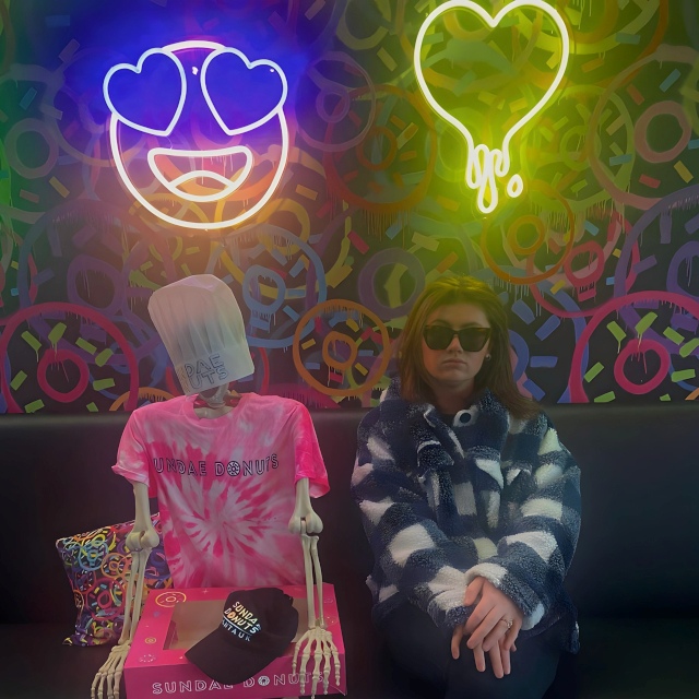 Halloween selfie taken @sundaedonutspiervillage featuring Custom Neon® wall art against donut wallpaper photo@kristinpurdy_official