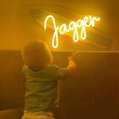 Custom Neon® yellow UV print surfboard name sign in boys room @janamaymargo