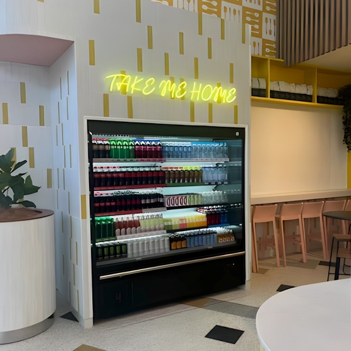 Bright yellow Custom Neon® Take Me Home sign above the drinks fridge  @thelittlespoonco