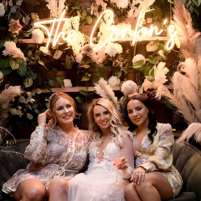 Custom Neon® last name wedding sign as selfie station backdrop