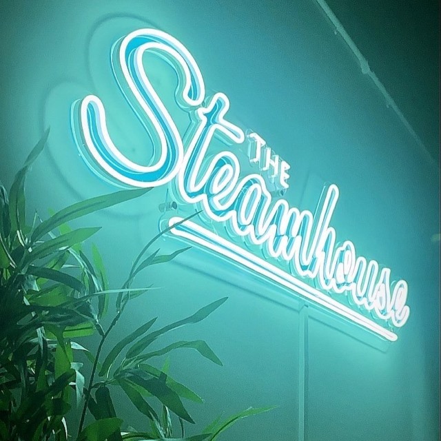 Custom Neon® mint LED neon @thesteamhousebakery business sign with blue UV print