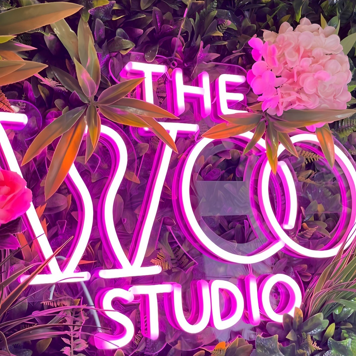 Pink Custom Neon® company name sign on a flower wall @thewoostudio_