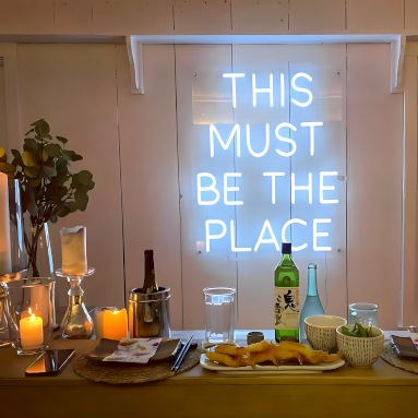 This Must Be the Place white Custom Neon® quote sign on white wood paneled wall @urbancookery
