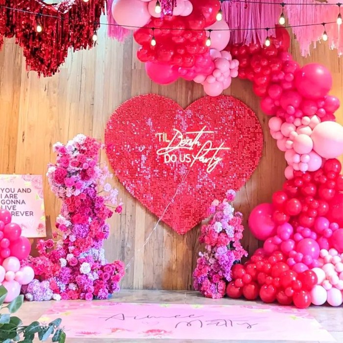 Til Death Do Us Party Custom Neon® sign on a shimmer heart as the wedding ceremony backdrop with a balloon waterfall styled @boutiqueballoons.melbourne