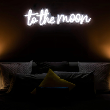 To the moon white Custom Neon® sign above a bed