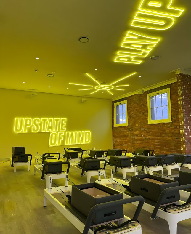 Large yellow Custom Neon&reg; branded signs and artwork on the wall & ceiling @upstate_studios