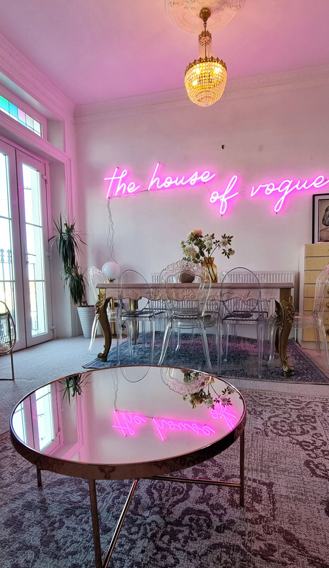 Pink Custom Neon® The House of Vogue sign in airbnb listing