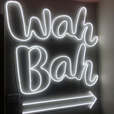 Custom Neon® white retro style arrow sign pointing to the bar @wahwahgee nightclub