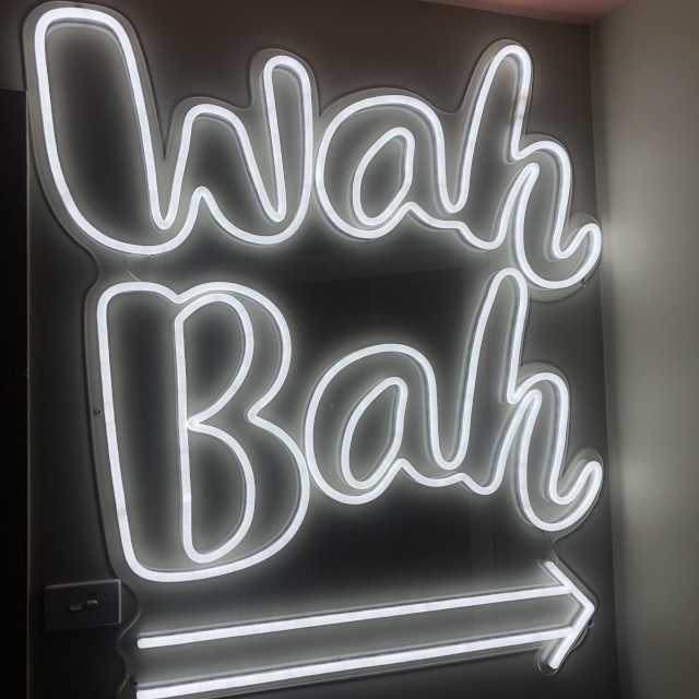 White directional restaurant name signage by Custom Neon® @wahwahgee