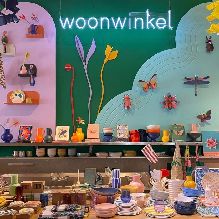 Custom Neon® white store name sign on a feature wall above merchansise @woonwinkelhome photo@kristinvanbuskirk